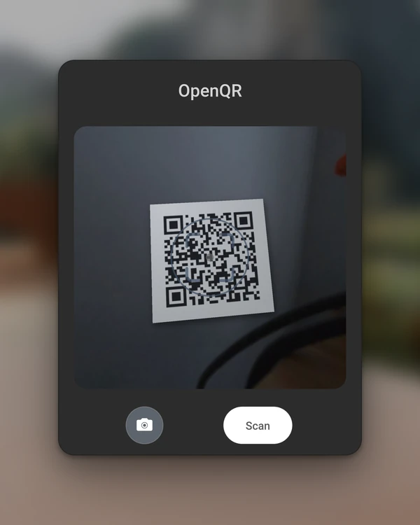 The OpenQR panel with the camera preview turned on, showing the room through the passthrough cameras and a printed QR code lined up under the target ring